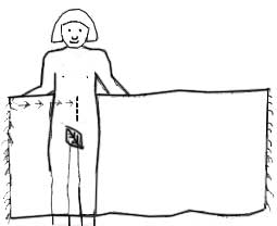 Start by holding the sarong behind your back